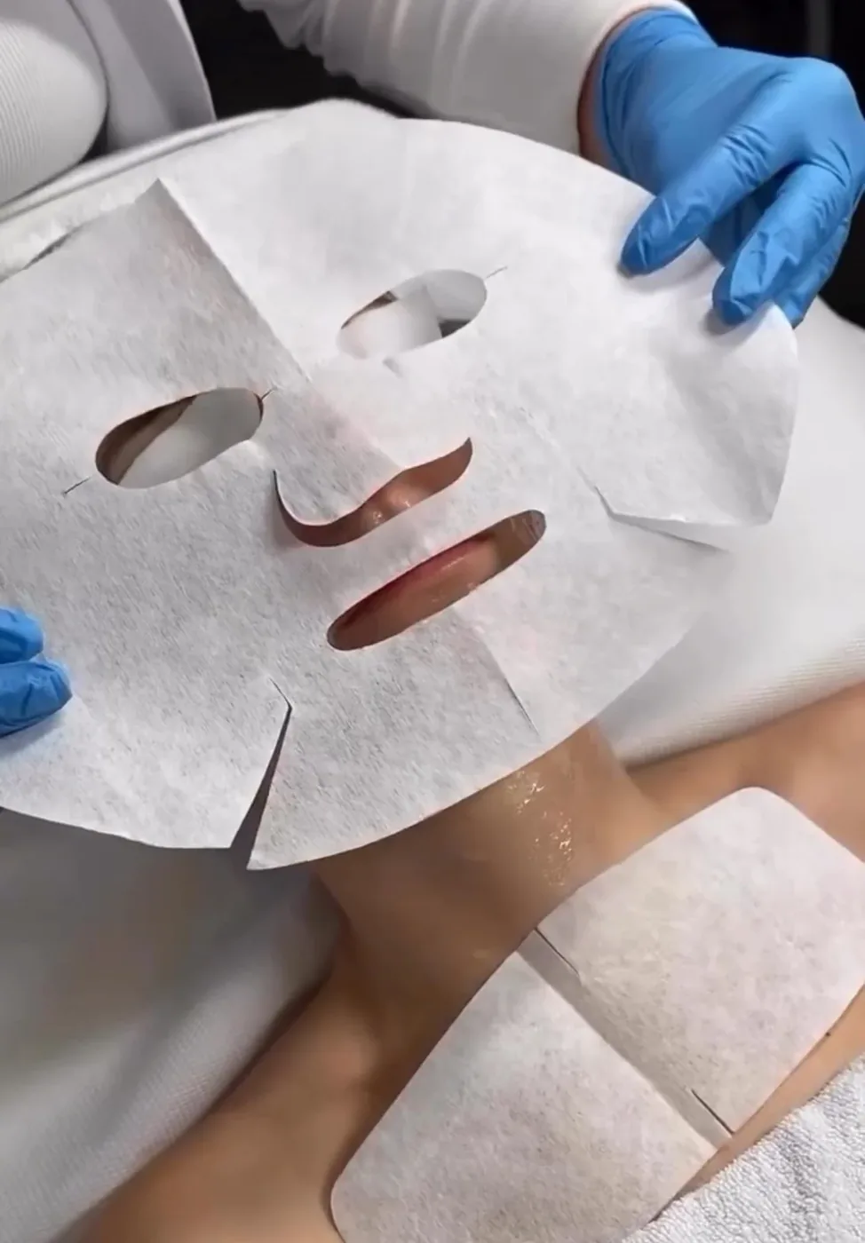 Sheet mask being applied during an anti-aging treatment.